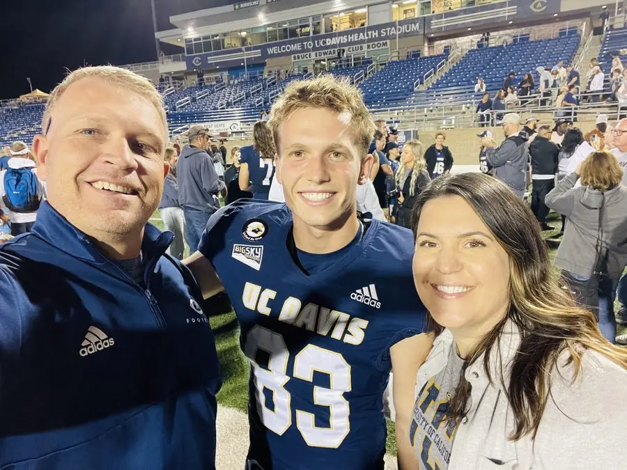 Founder with parents on the field at UC Davis Health Stadium after a game