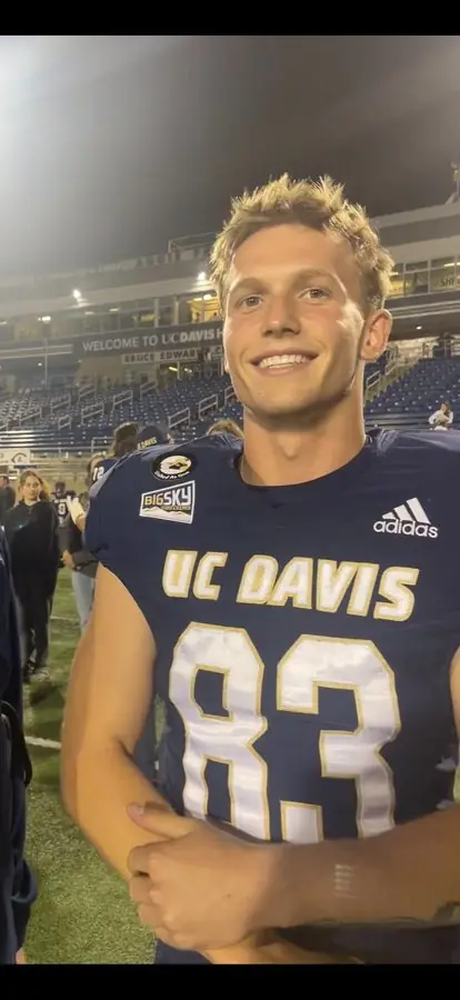 Founder of Aggie Home Solutions in UC Davis football jersey #83 at UC Davis Health Stadium